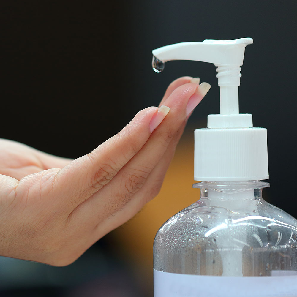 Foto Dispenser  gel disinfettante e mano femminile